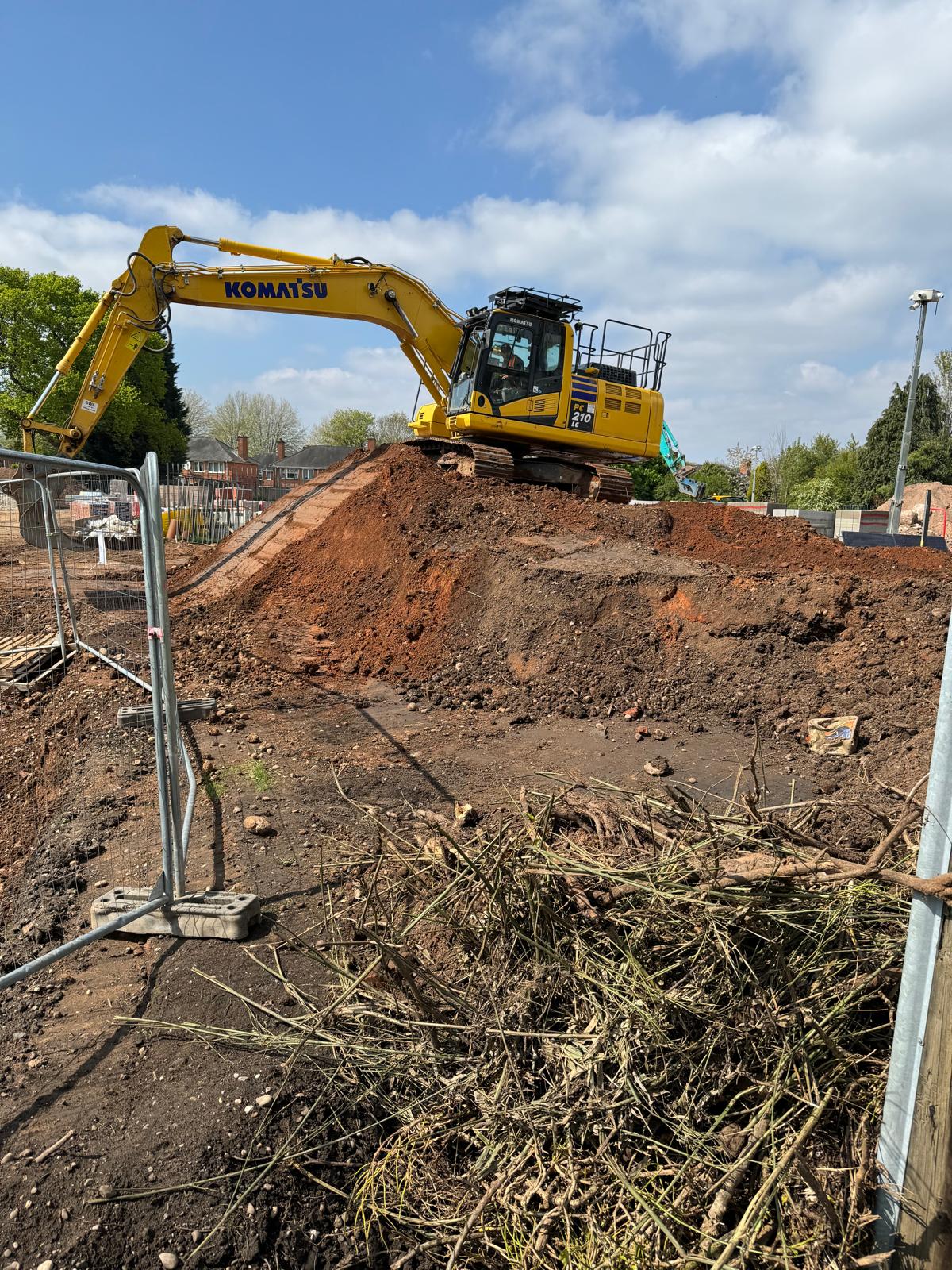 Excavator carrying out groundworks and earthmoving on a Midlands site