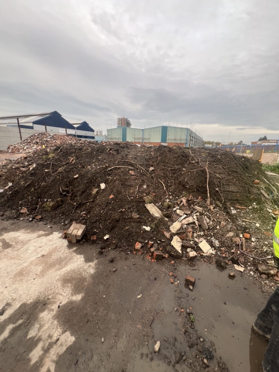 Large stockpile of spoil and brick rubble awaiting removal from a Wolverhampton commercial site
