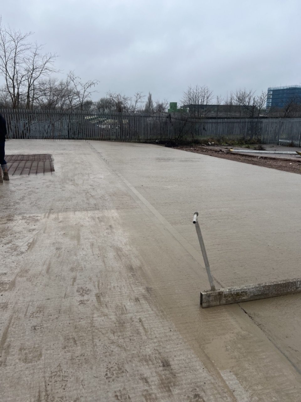 Newly poured and tamped industrial concrete slab at a commercial yard in Wolverhampton
