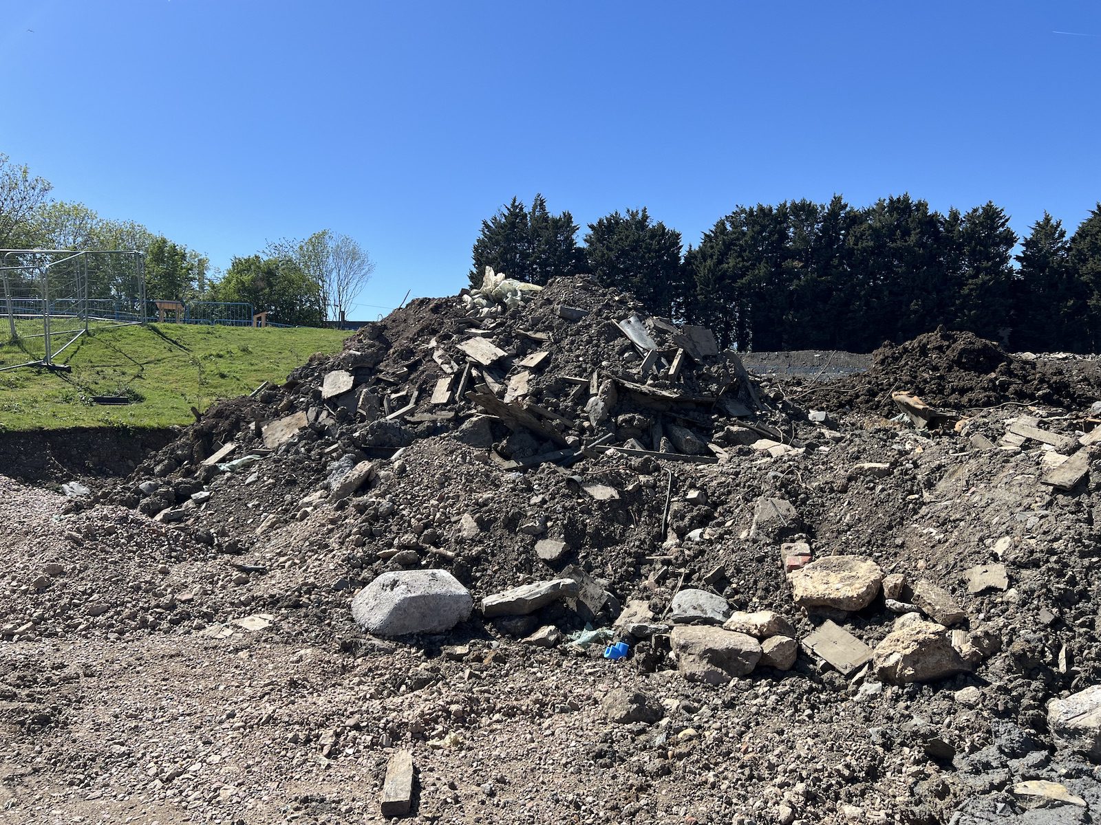 Demolition arisings of soil, broken concrete and timber stockpiled on the Coventry site