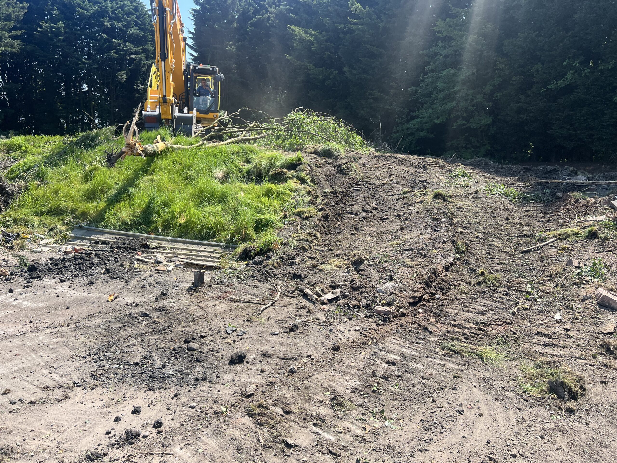 Plant machine working a soil pile on a Midlands site