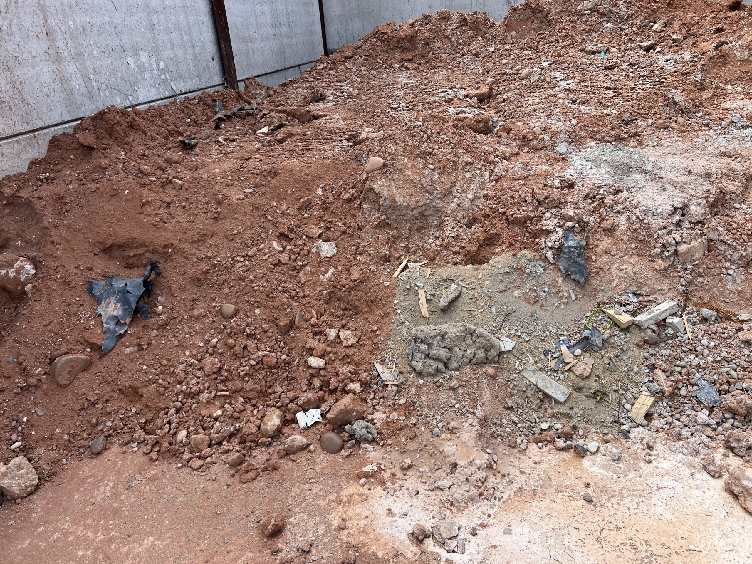 Stockpile of sand, soil and mixed waste awaiting removal to a licensed facility