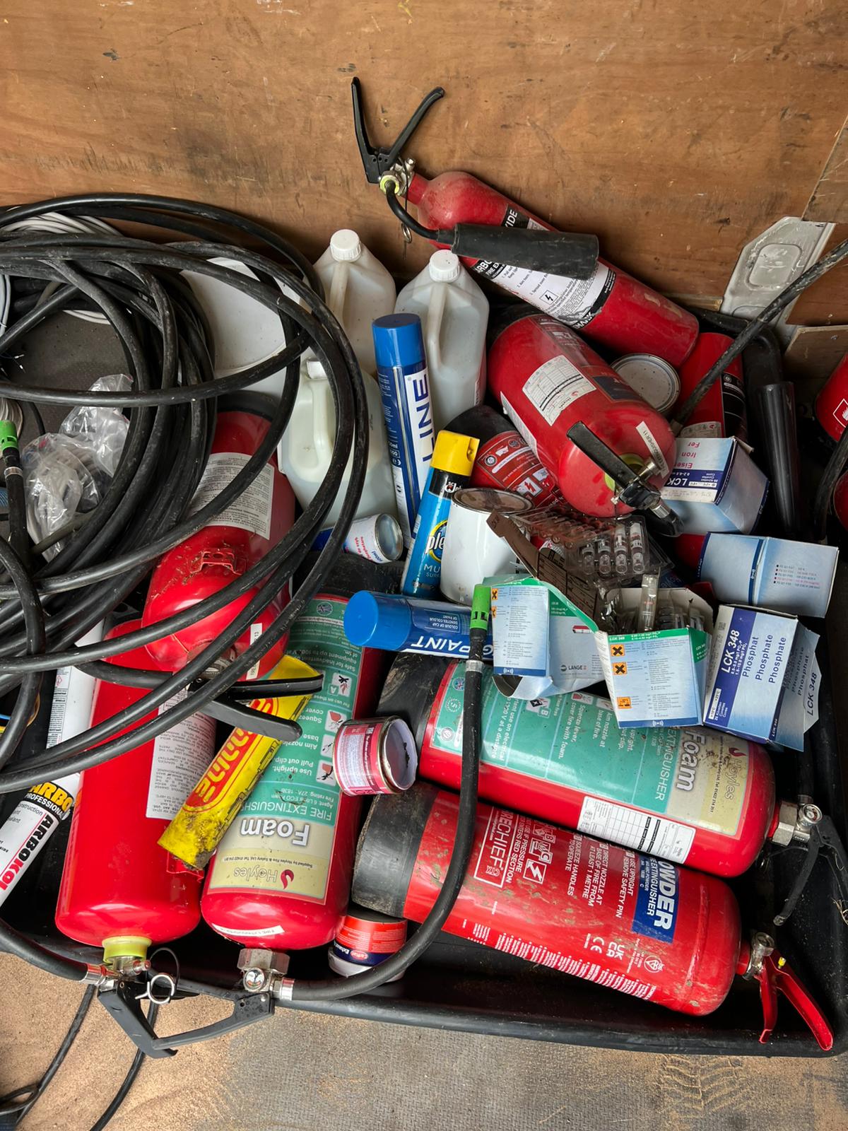 COSHH chemical waste and fire extinguishers awaiting compliant collection