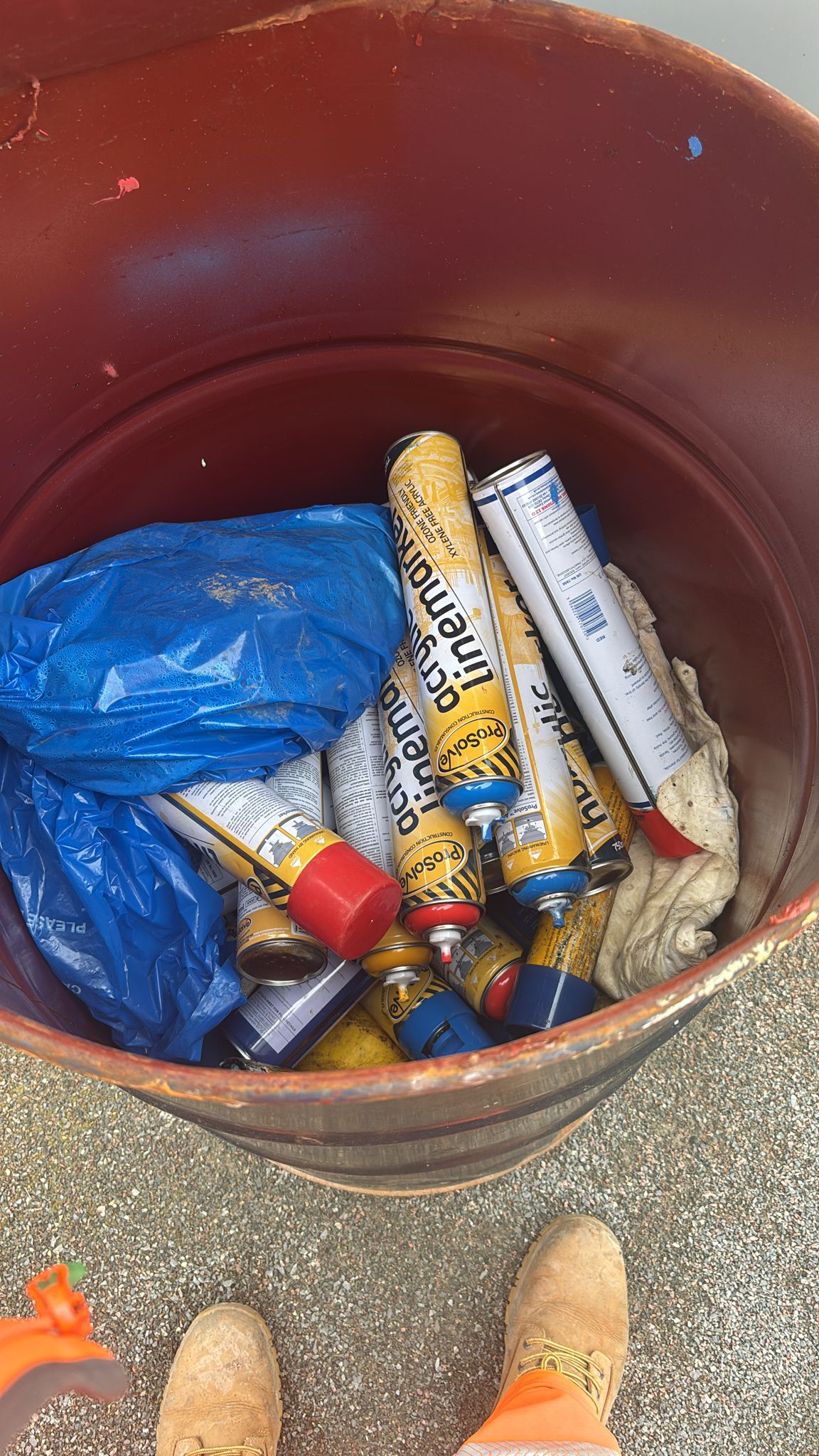 Aerosol cans contained in a 45-gallon drum for hazardous waste collection